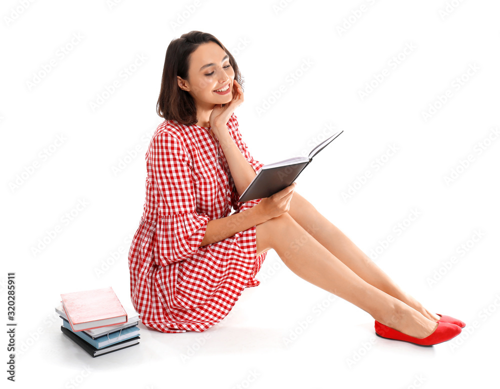 Beautiful young woman with books on white background