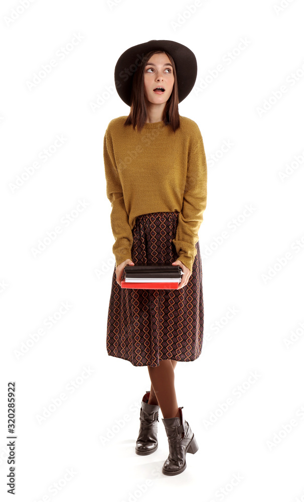 Beautiful young woman with books on white background