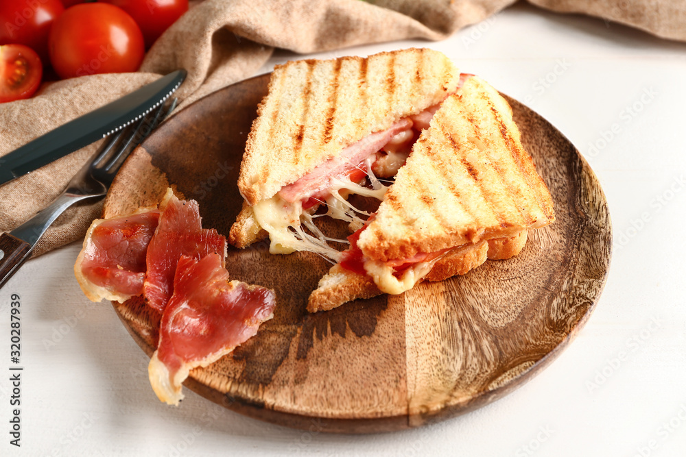 Plate with tasty sandwiches on table