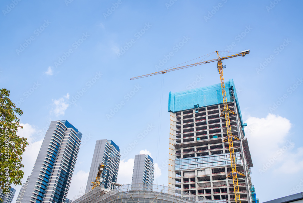 Upside-down shot of city construction site cranes and real estate