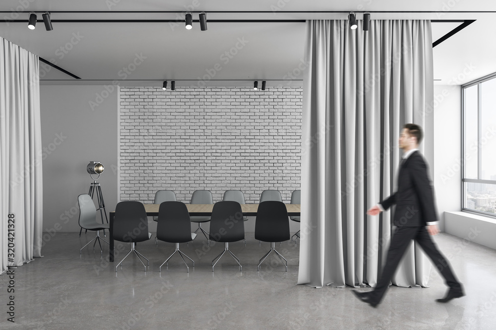 Businessman walking in meeting room interior