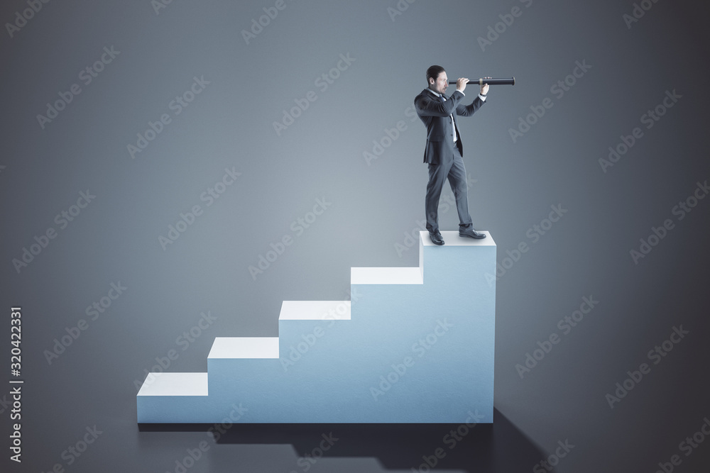 Businessman standing on concrete ladder