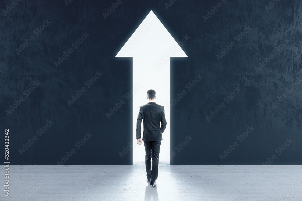 Businessman walking to abstract white arrow