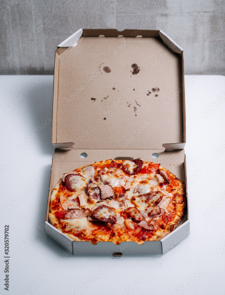 Traditional italian pizza in cardboard box.