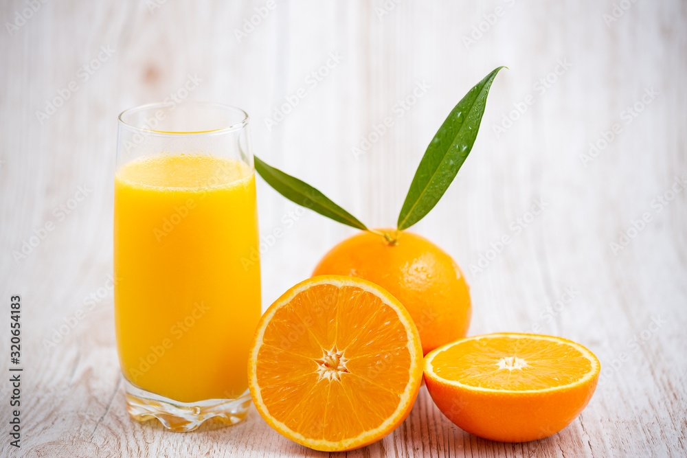 Natural fresh fruit oranges in a wooden background backdrop, half cut oranges, orange juice, vitamin