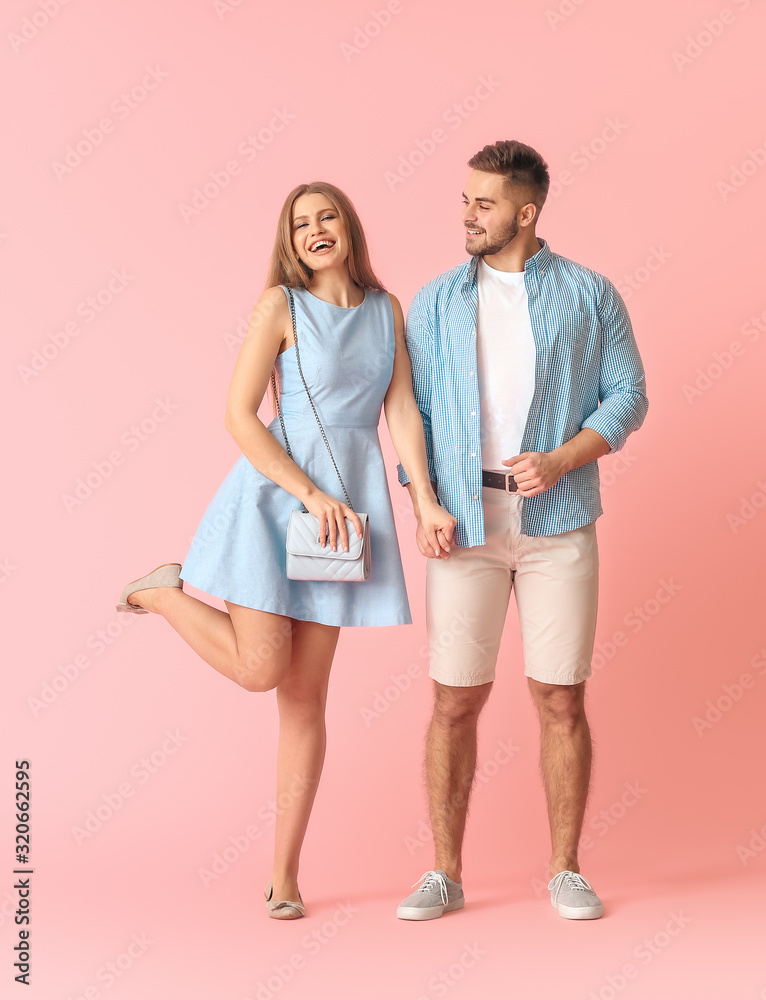 Happy young couple on color background