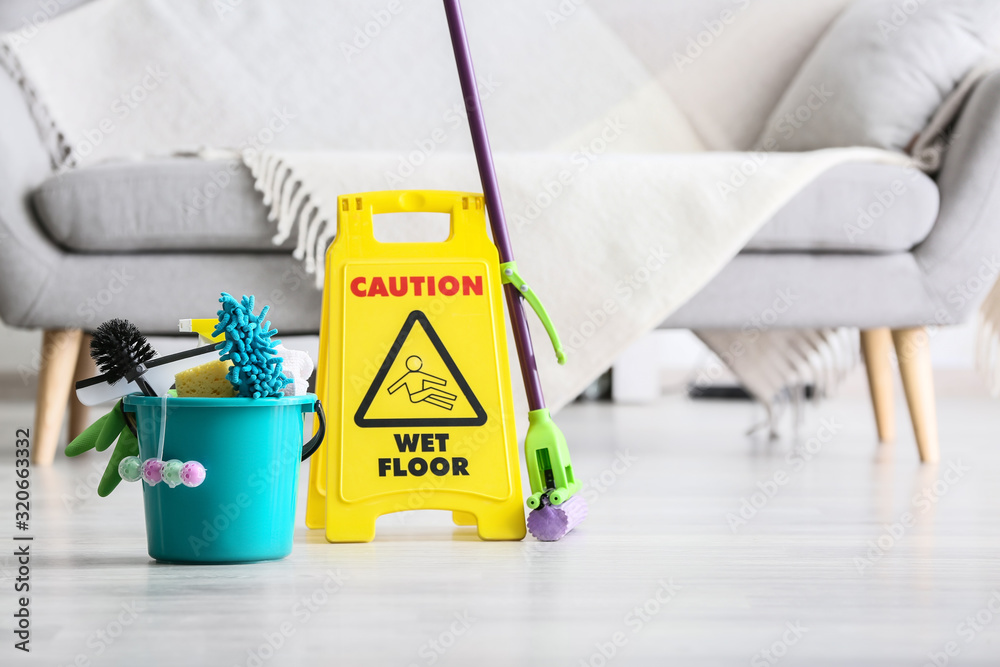 Set of cleaning supplies on floor in room