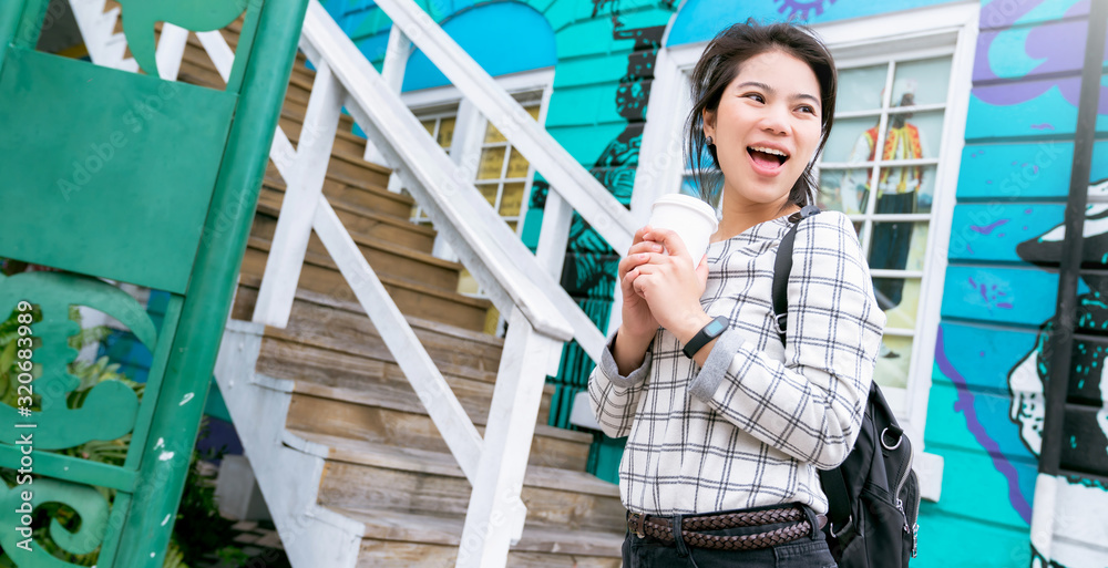 closeup asian woman hand hold coffee drink traveller with background of house architecture,asian pho