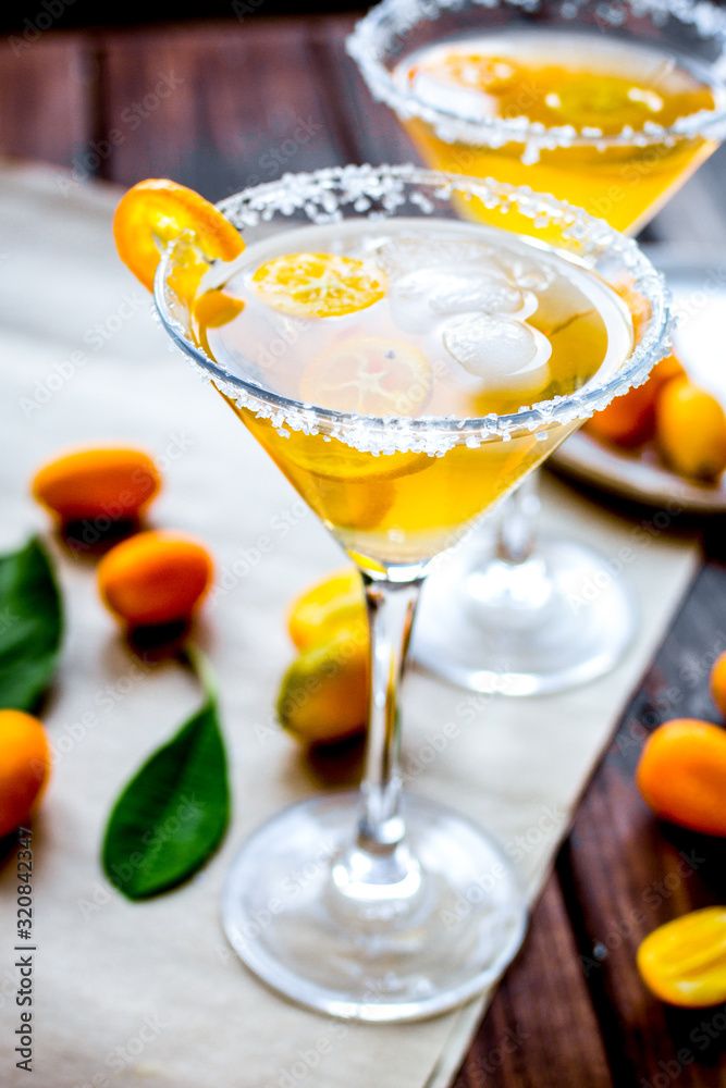 cocktail with kumquat on wooden background