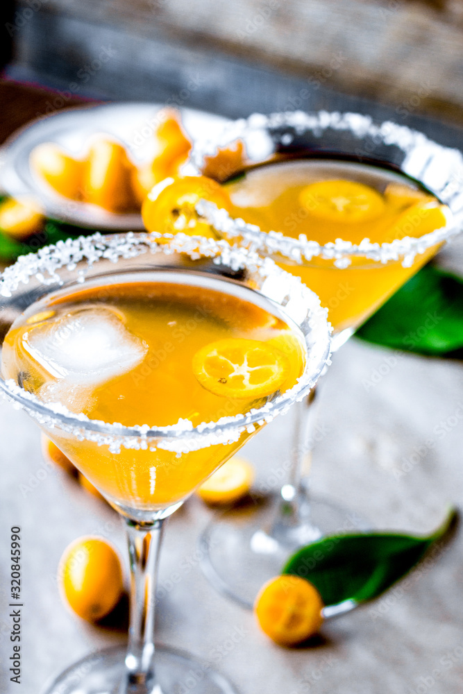 cocktail with kumquat on wooden background