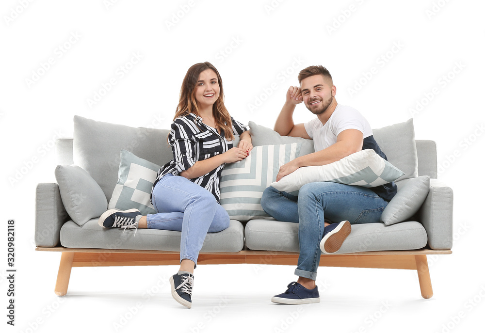 Young couple sitting on sofa against white background