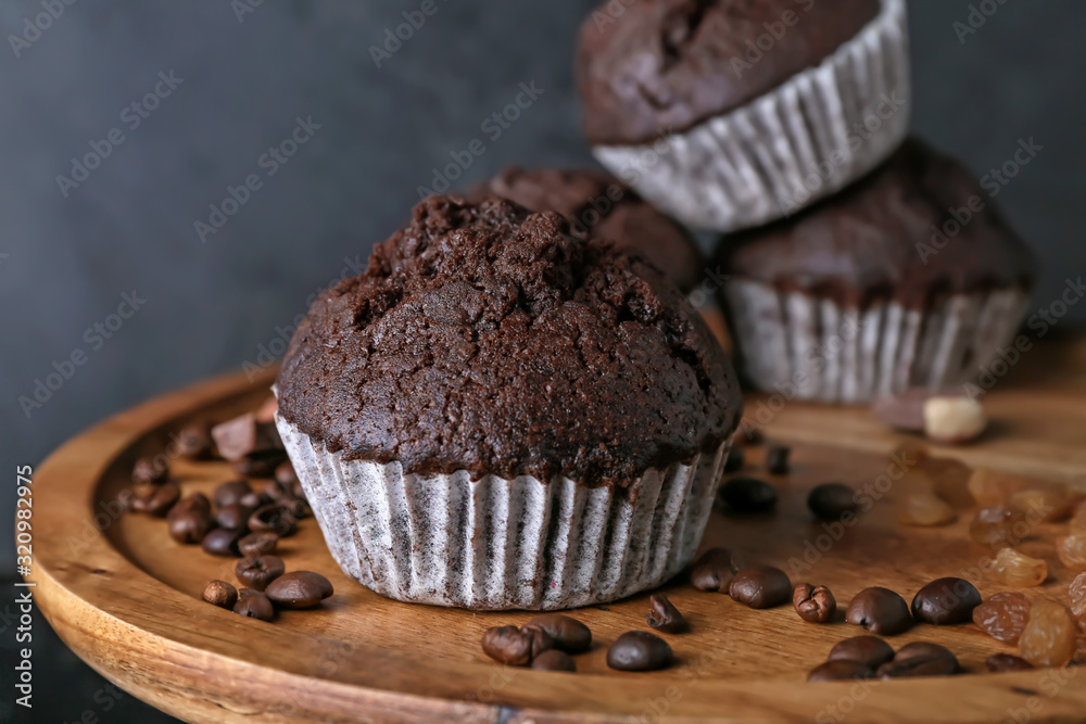 Tasty chocolate muffins on stand, closeup