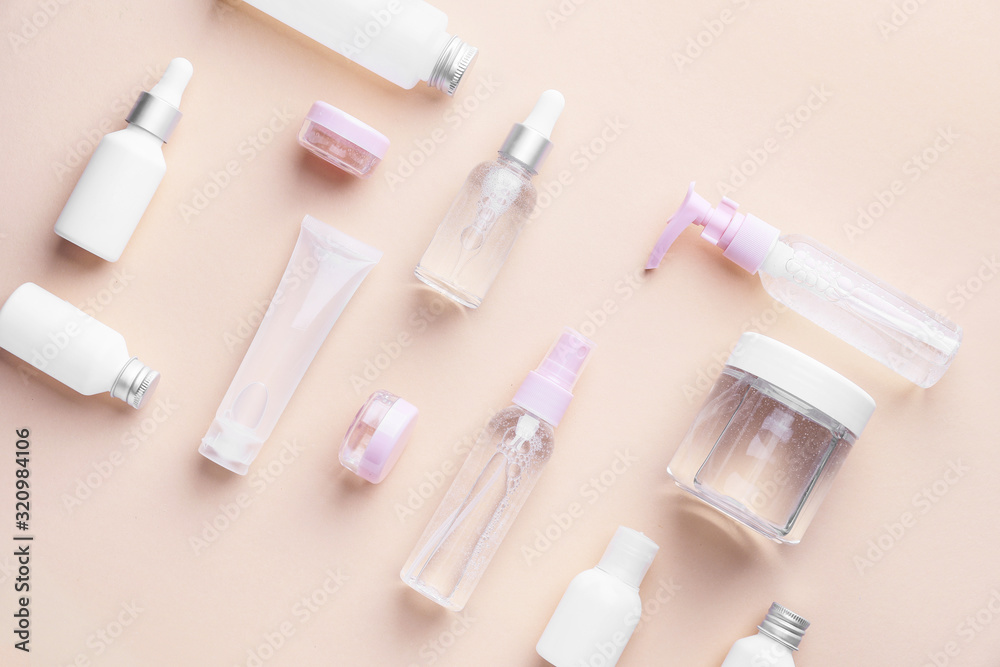 Different cosmetic products on color background