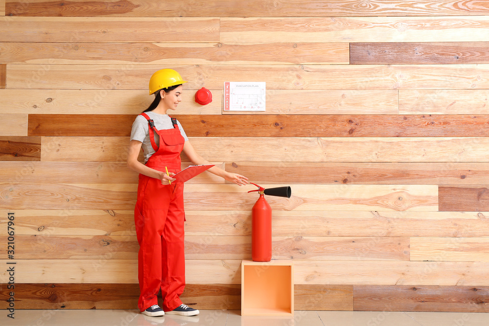 Fire safety specialist inspecting extinguisher