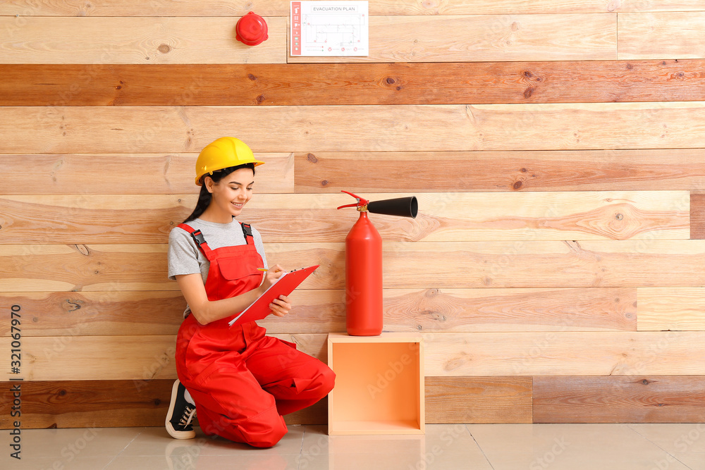 Fire safety specialist inspecting extinguisher