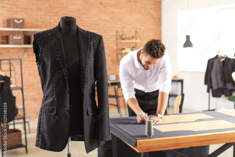 Mannequin with half-finished male suit in tailors workshop