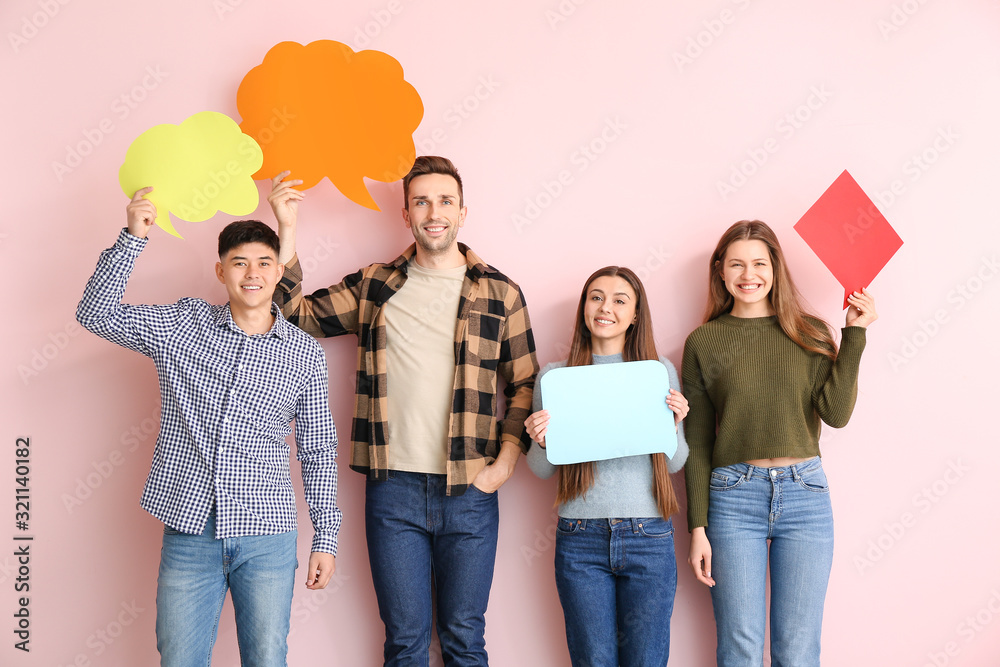 Group of young people with blank speech bubbles on color background