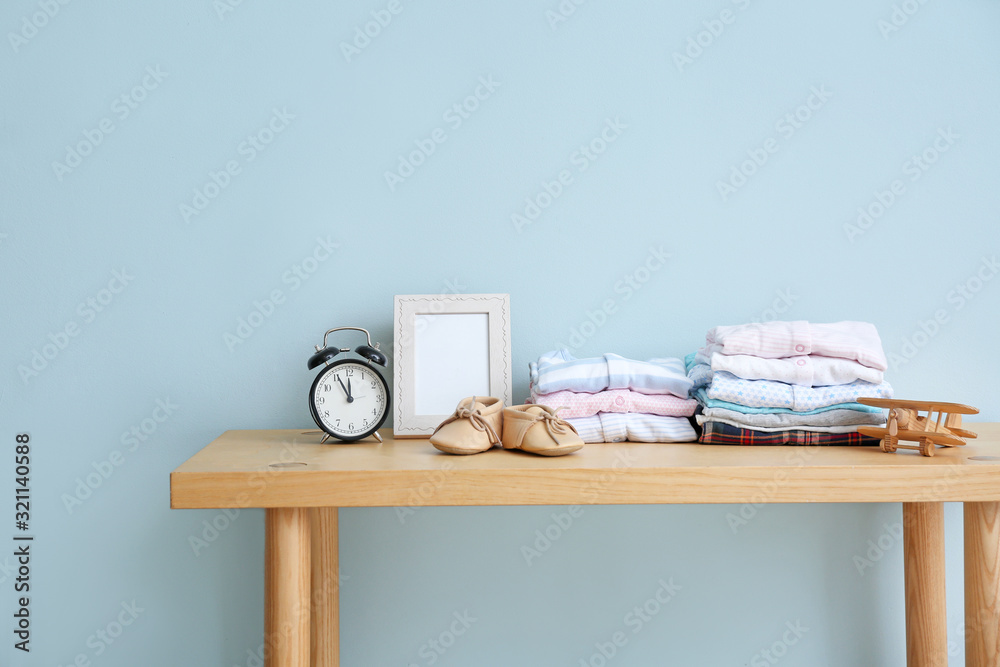 Baby clothes on table in room