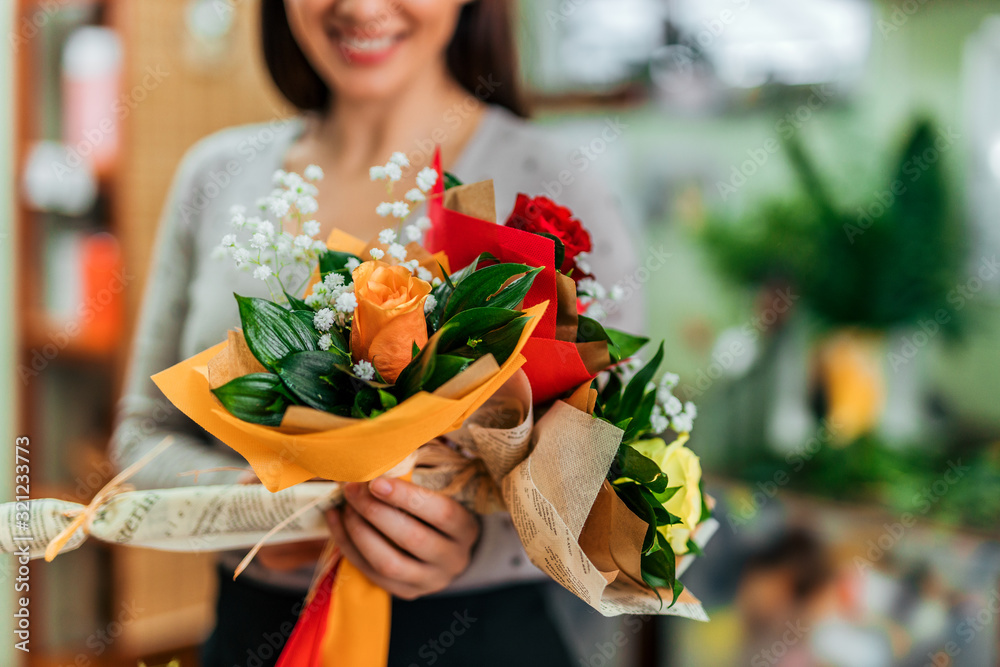 Beautiful flower bouquets. Close-up image of florist holding three different fresh flower bouquets t