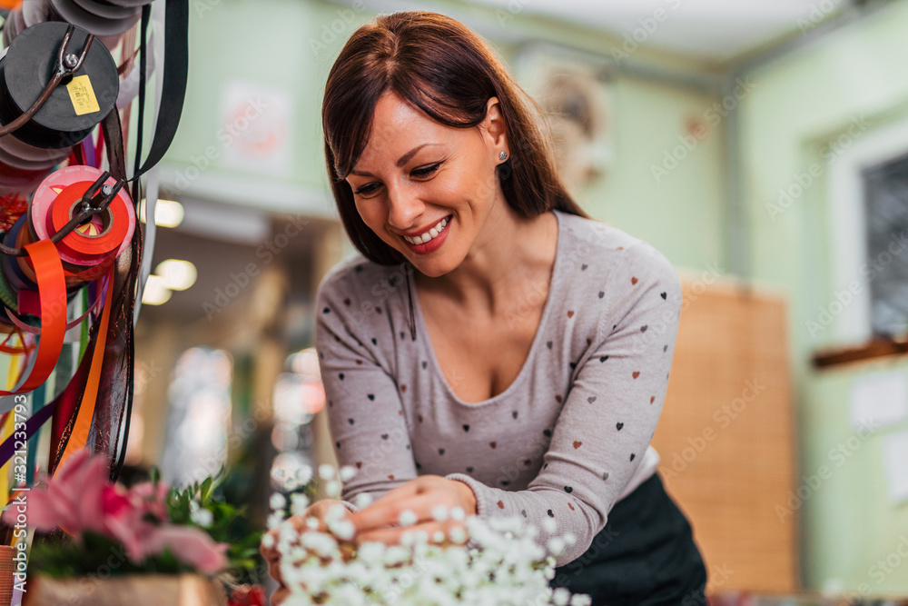 Portrait of a happy florist at work, close-up.