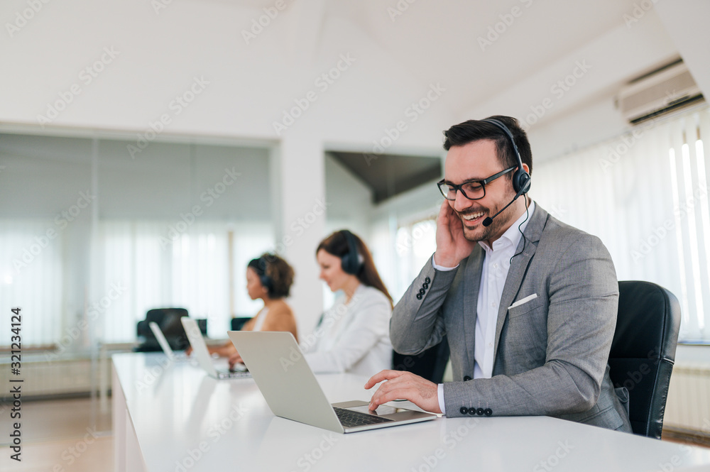 Smiling helpline operator consulting a client, portrait.