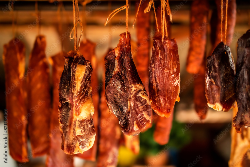 Smoked prosciutto hanging. Homemade food production.