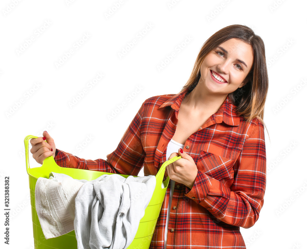 Beautiful young woman with laundry on white background