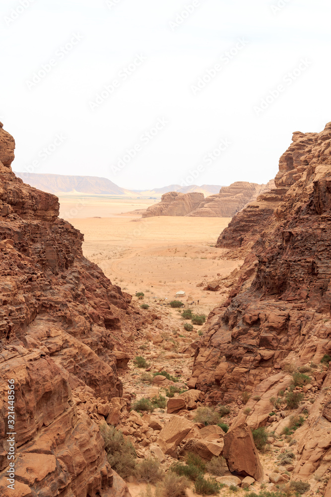 Wadi Rum desert panorama seen from canyon with dunes, mountains and sand, Jordan