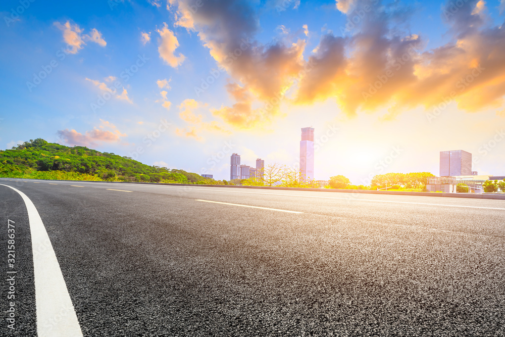 Empty asphalt road and Shenzhen city architectural scenery,China.