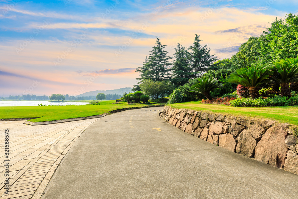 Cement road and green forest with mountain in summer.