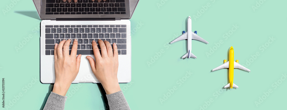 Flights online booking and reservation theme with person using a laptop computer