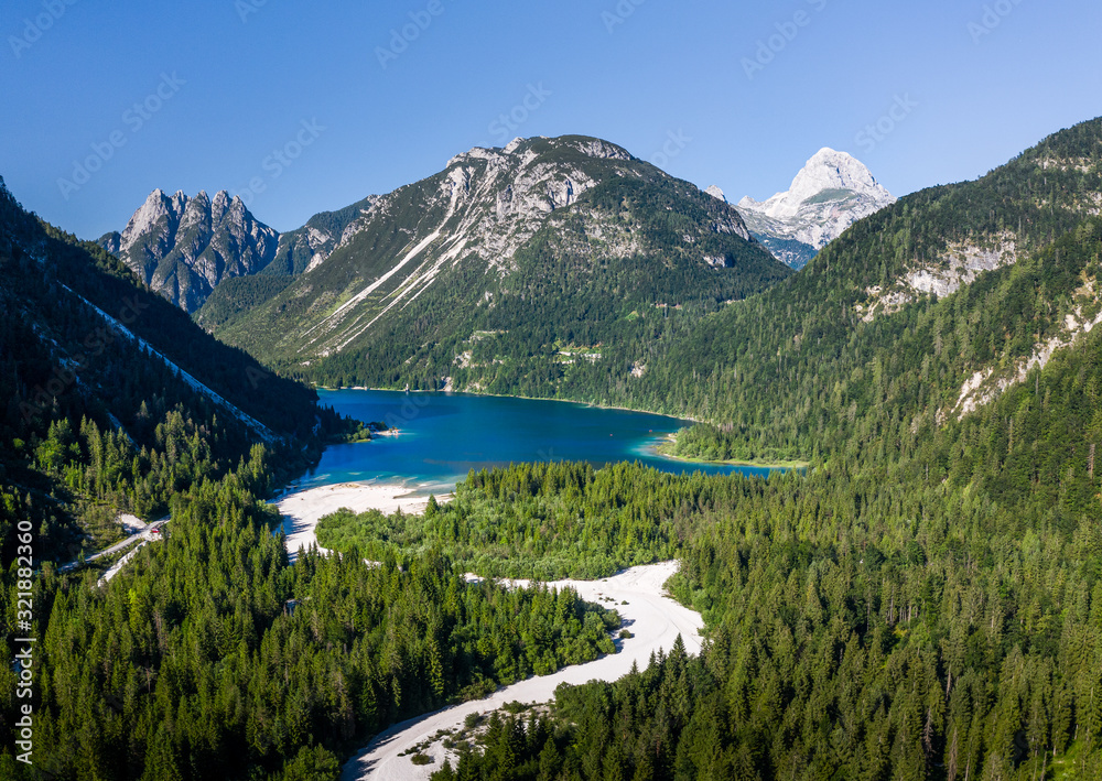 idyllic mountain lake in the Alps with the mountain Mangart in the background