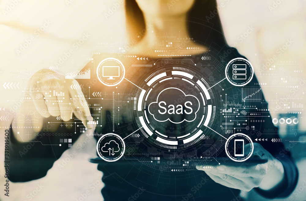 SaaS - software as a service concept with businesswoman on a city background