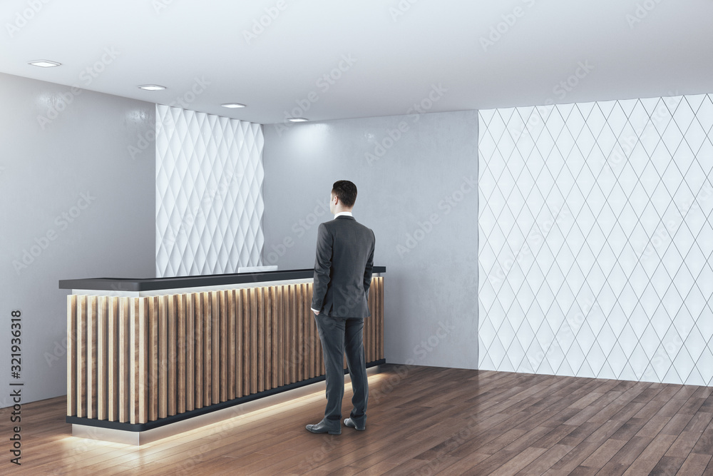 Businessman standing in modern hotel hall