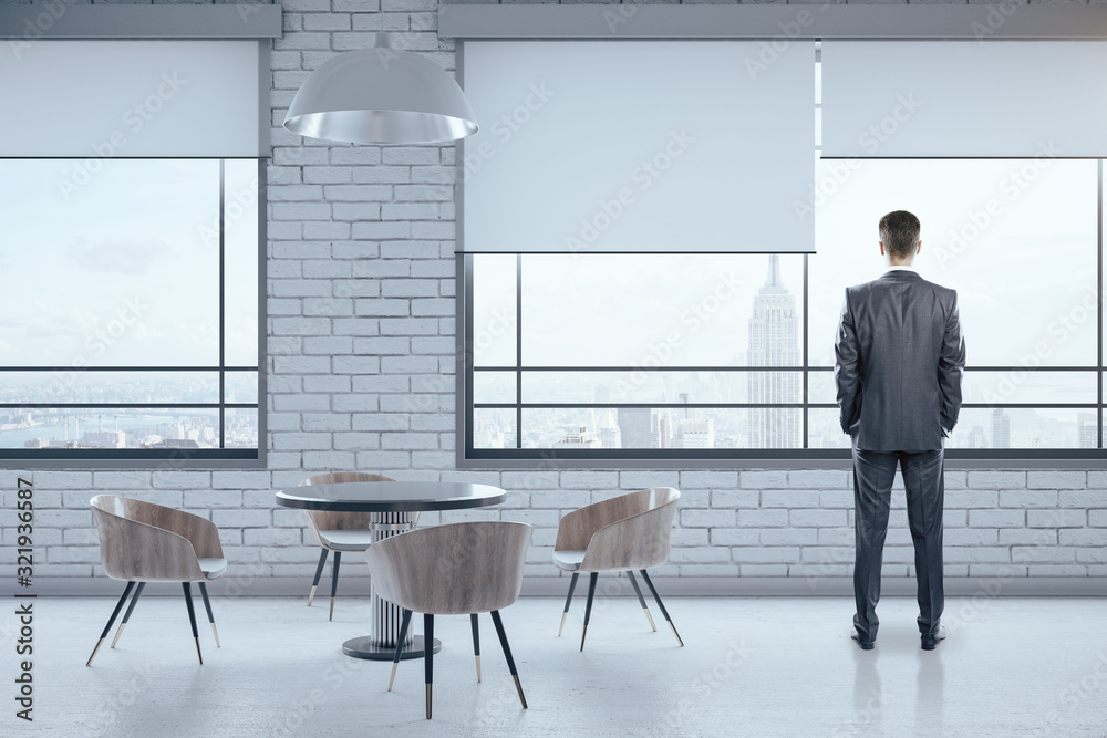 Businessman standing in waiting room interior