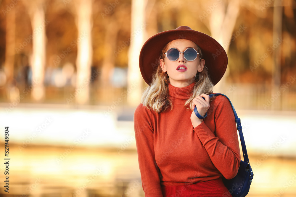 Portrait of fashionable young woman near river