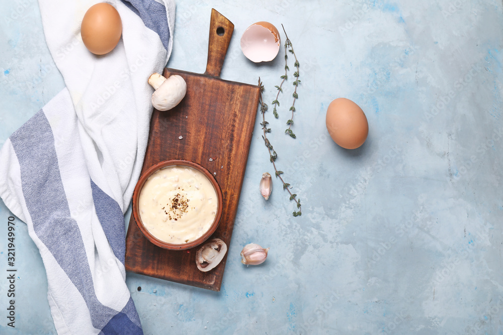 Bowl with mushroom sauce on color background