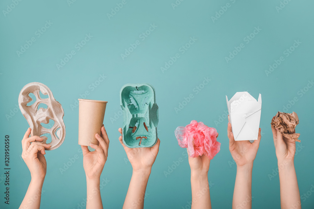 Hands with garbage on color background. Concept of recycling