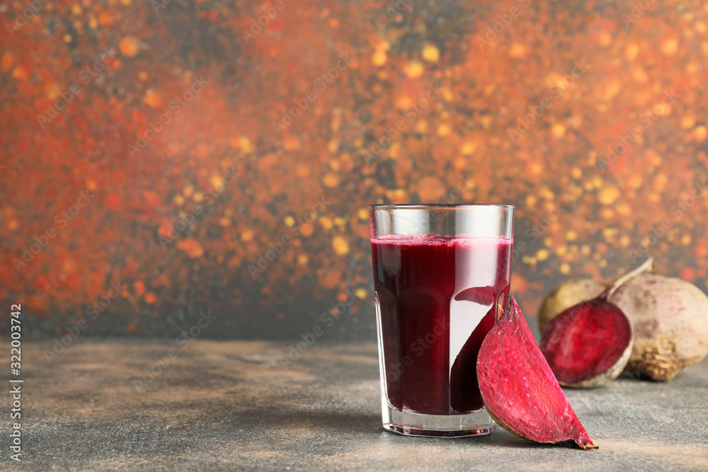 Glass of fresh vegetable juice on color background