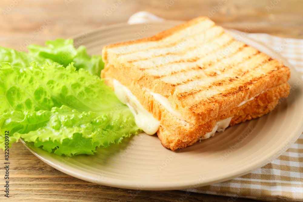 Tasty sandwiches with cheese on plate