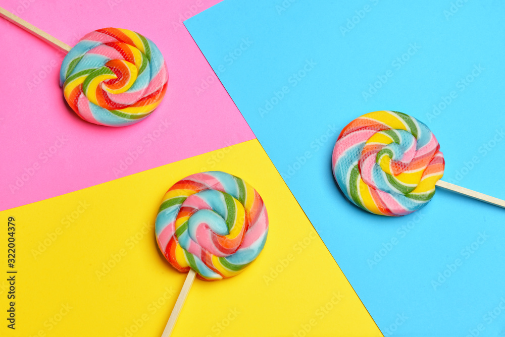 Tasty lollipops on color background