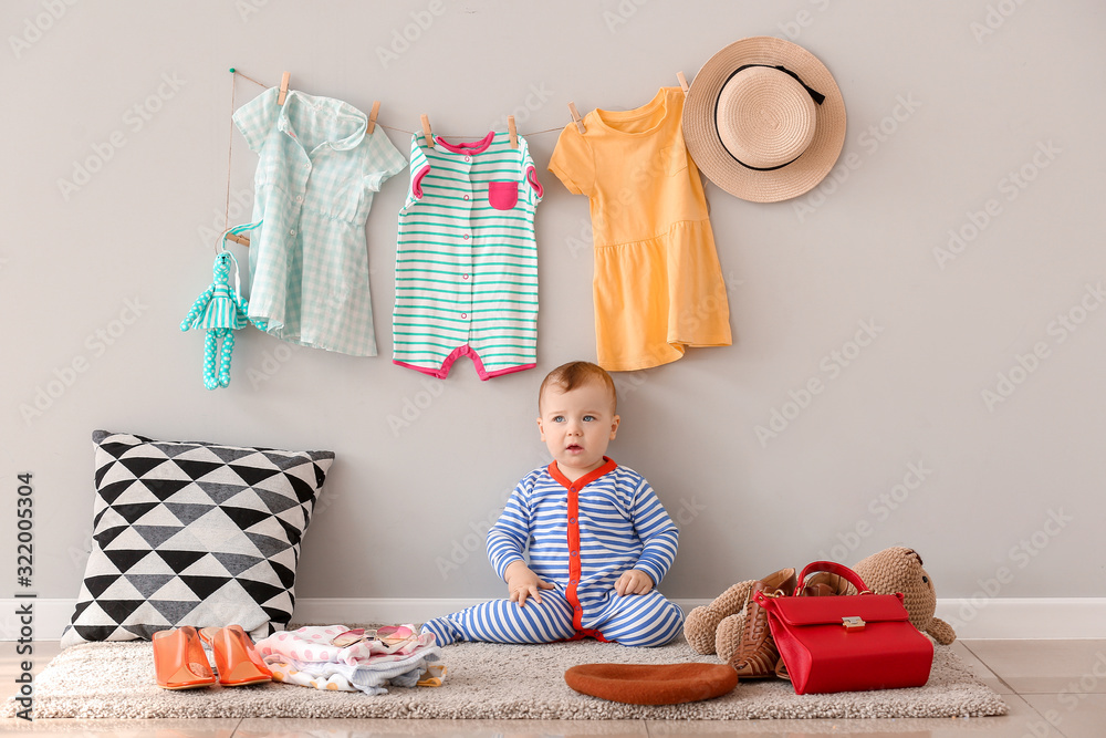 Cute baby with stylish clothes and accessories at home