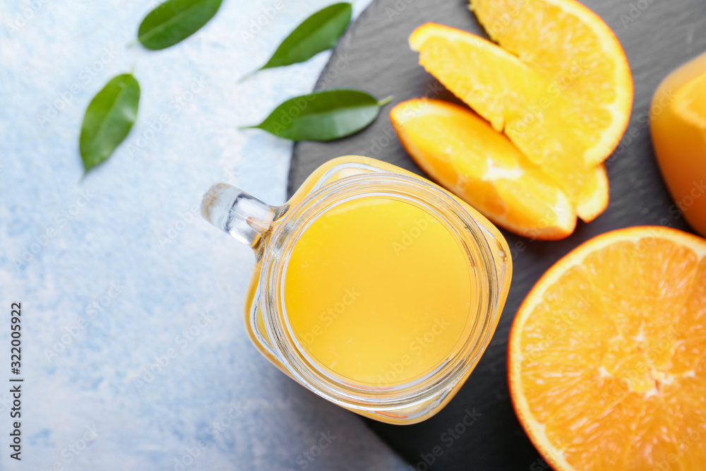 Mason jar of fresh orange juice on table