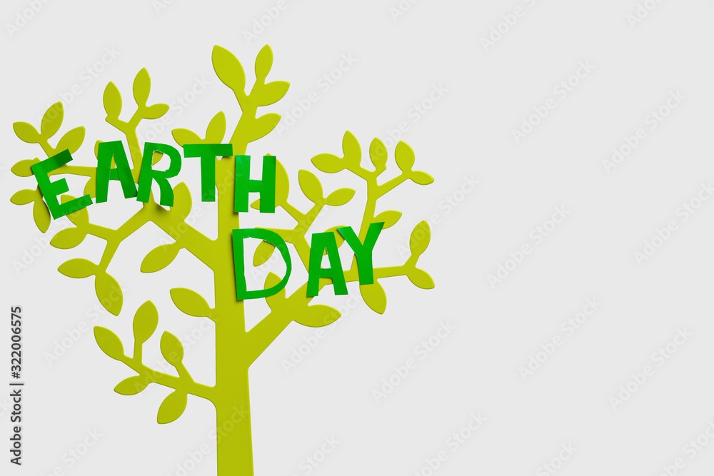 Figure of tree with text  EARTH DAY on light background