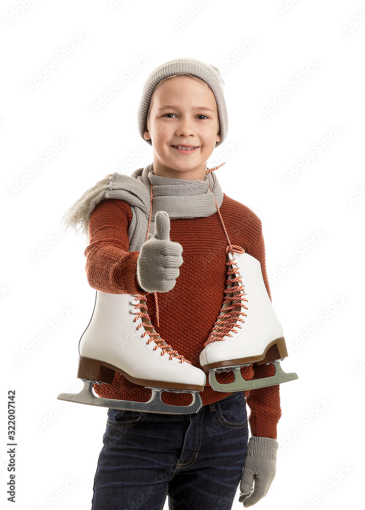 Cute little boy with ice skates showing thumb-up against white background