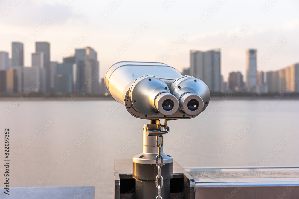 telescope with city skyline