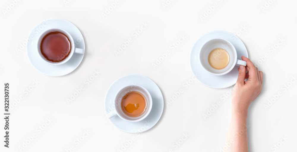 Female hand holding a tea cup overhead view - flat lay