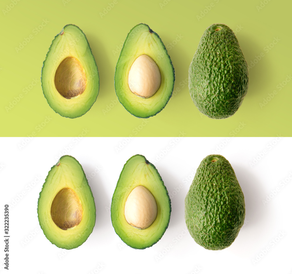 Avocado on the green and white background. Top view