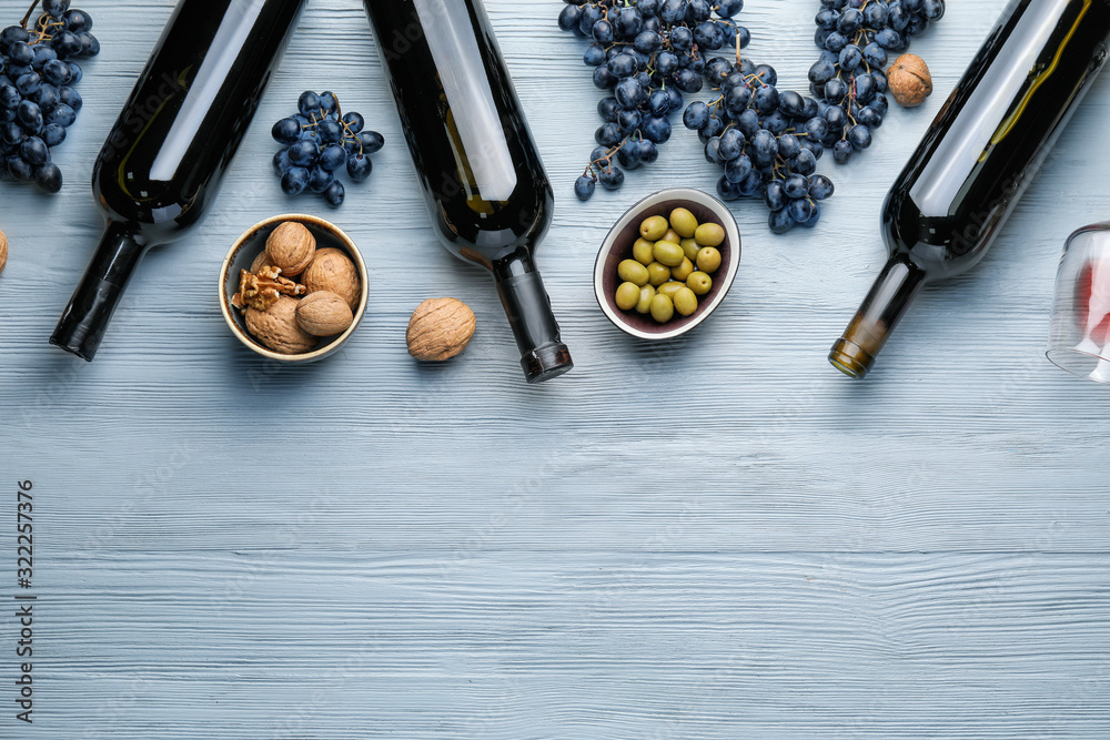 Delicious wine with snacks on wooden background