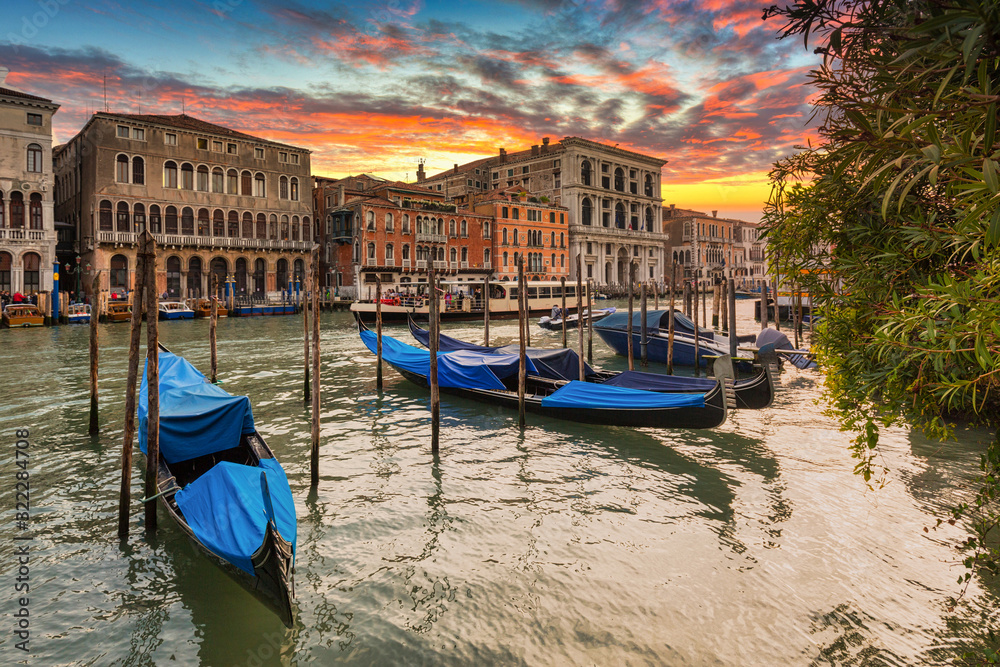 Canals of Venice city at sunset with traditional colorful architecture, Italy